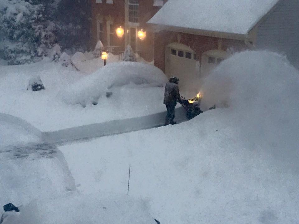 Clearing a path for their dog, Riley, Mary Kay Downes's husband Linus uses their John Deere snowblower to remove approximately 14