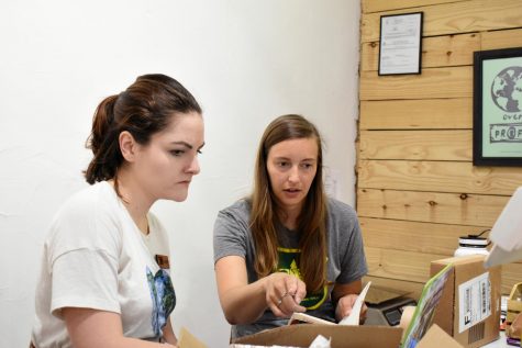 Allie Emerick (right) speaks with her employee about fulfilling orders. 