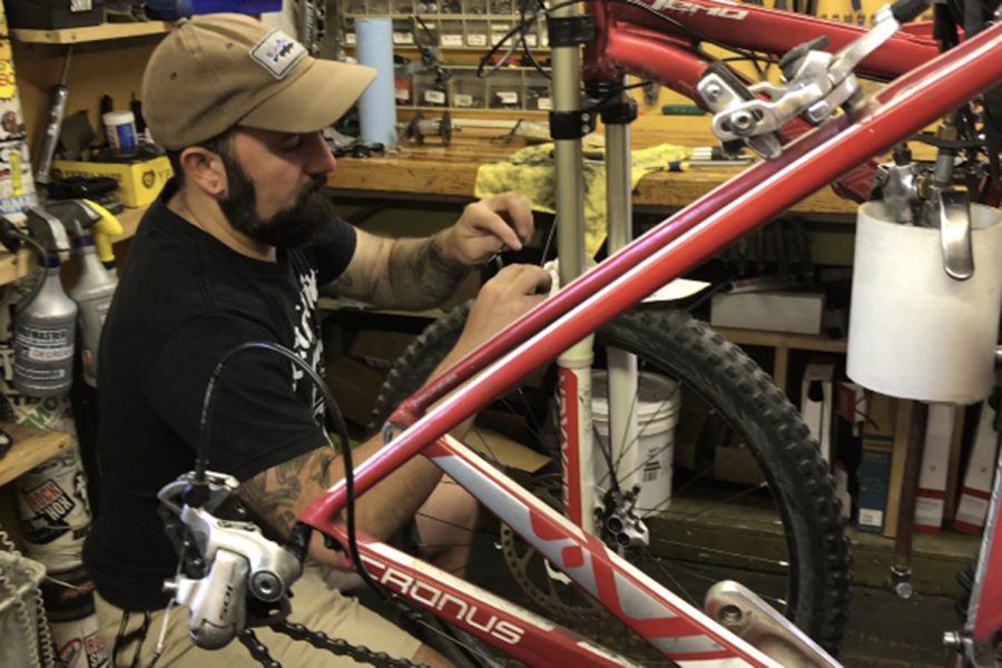 Shenandoah Bicycle Company mechanic Chris Regec works on a bicycle in shop.