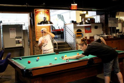 Jeanie Baker and Chase Jones play pool together in the arcade. Ruby’s has multiple pool tables throughout the restaurant and arcade.