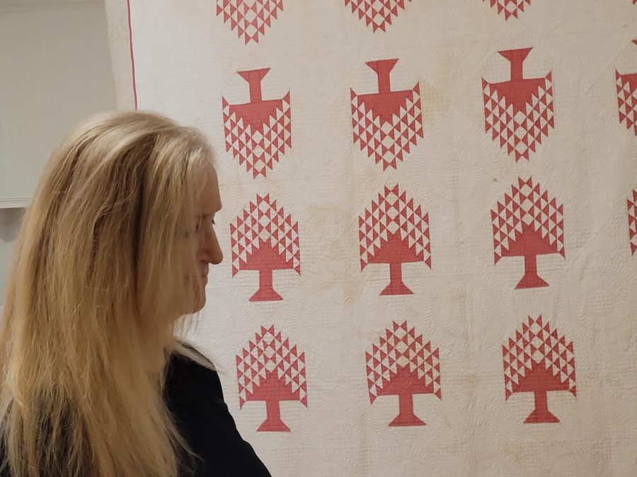 lady looking at a quilt