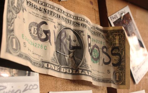 Dollar bill with "girlboss" written on it