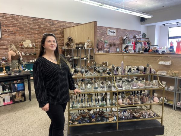  Owner of Boujie Hippie stands before her products 