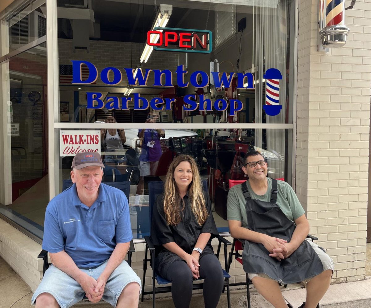 Rodriguez, Dean and Farmer pose infront of the Downtown Barber shop