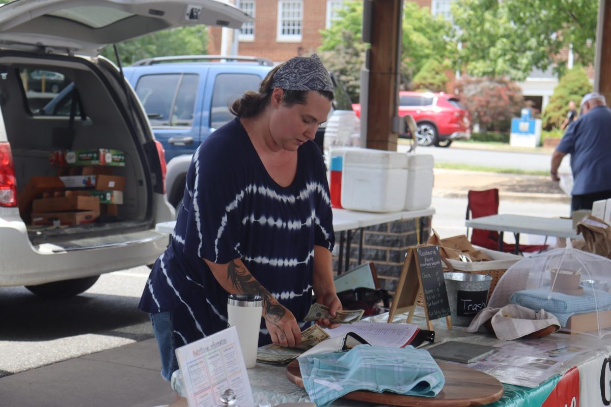 Betsy Ferris sells goat milk products to patrons of the Harrisonburg Farmers market while braving the high temperatures July 9. Her job at the market is among the many outdoor activities she does, ranging from foraging and gardening to taking care of free-range chickens. “I definitely find that if I've spent time outside I feel better, getting vitamin D from the sun or just walking barefoot in the grass,” Ferris said.