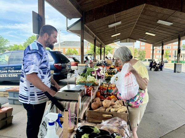 Local farmer assists customer with selecting produce on June 9, 2024, at the Harrisonburg Farmers Market. The market is open from 8 a.m. to 1 p.m. on Tuesday and Saturdays. 