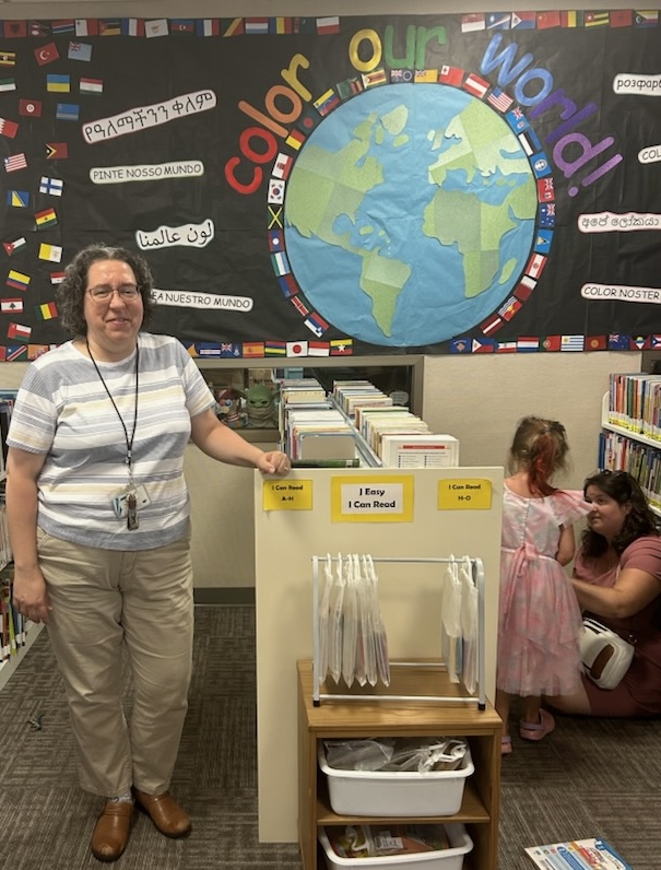 Youth Services Coordinator at the Massanutten Regional Library Denise Munro smiles in front of the “Color our World” sign in the Central Library. “Color the World” is this year’s theme of the library’s annual summer reading challenge. According to the Collaborative Summer Reading Program, which selected the theme, this year’s challenge is designed to “inspire and engage readers of all ages through a diverse array of artistic expressions.”