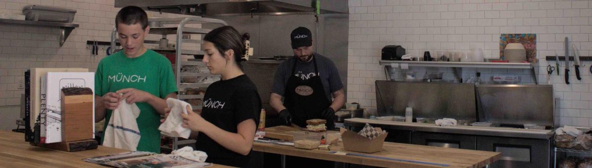 Inside the Münch sandwich shop employees, Jackson Ingram and McKayla Suffecool, fold hand towels.